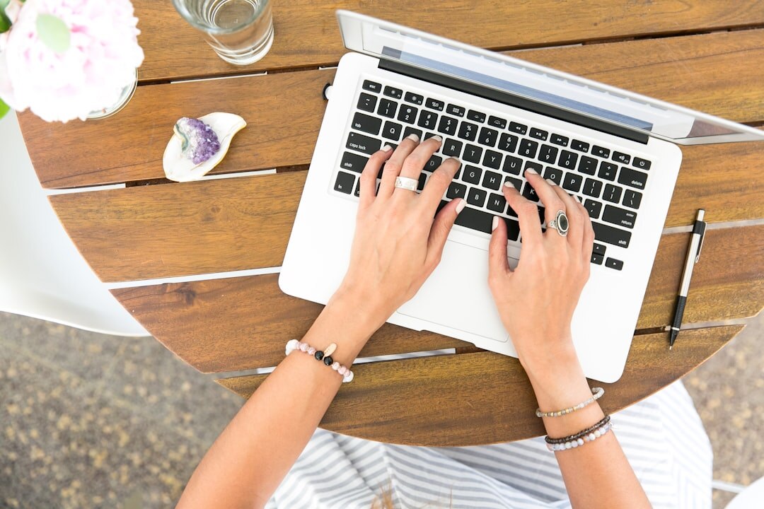blogger typing on laptop