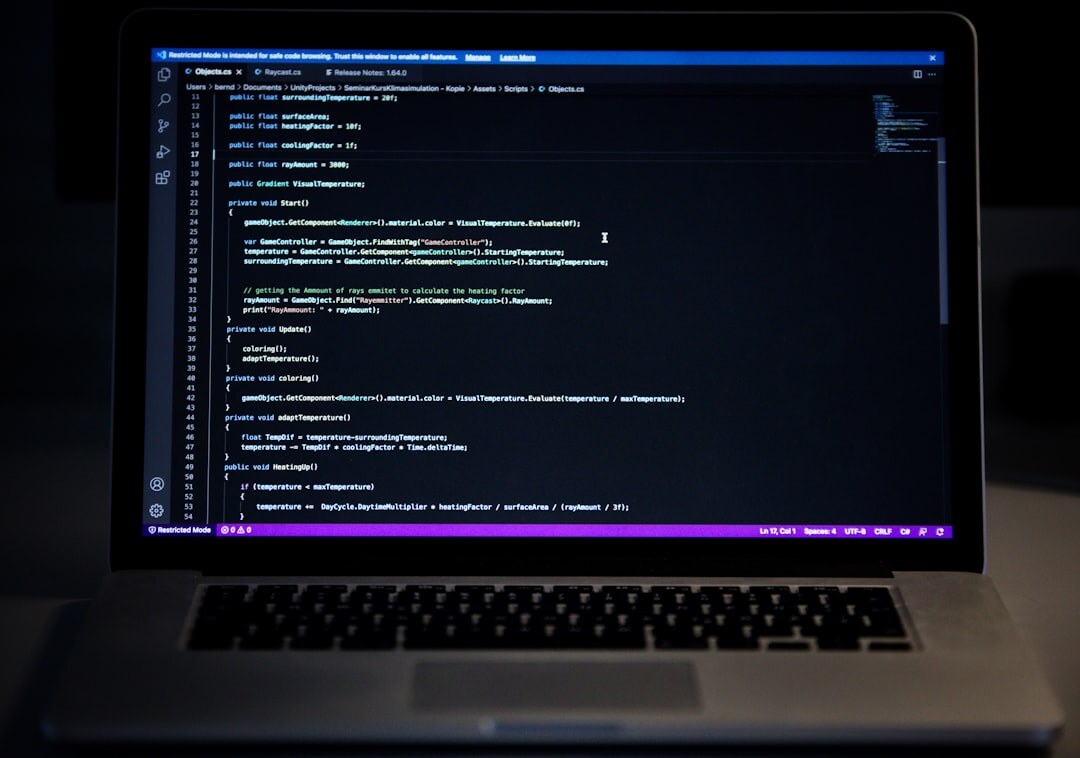 programmer coding on laptop