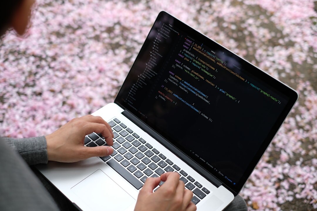 person coding on laptop