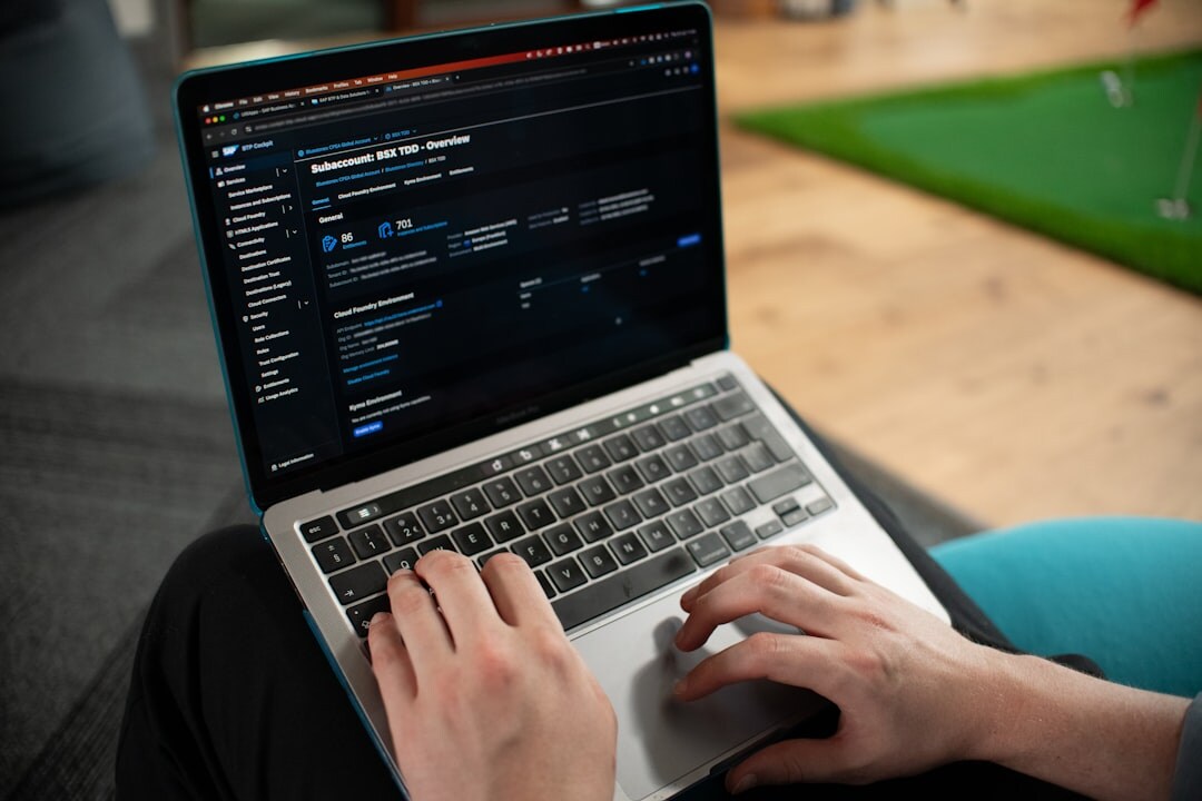 programmer coding on laptop