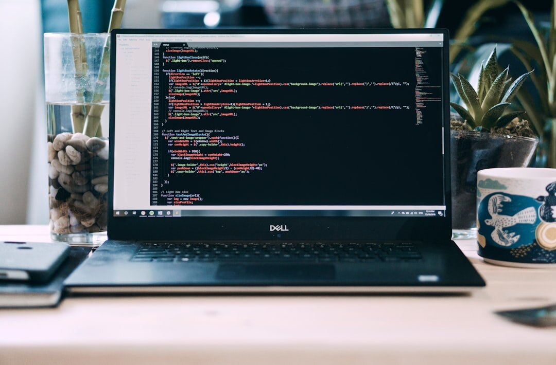 programmer typing code on laptop